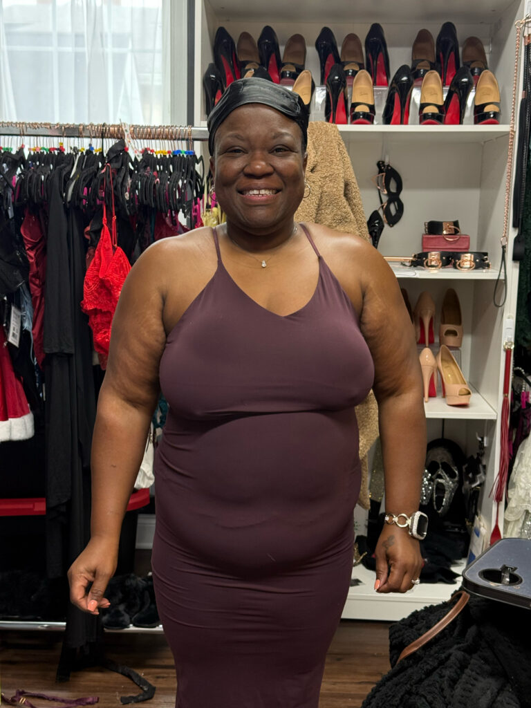 Smiling woman in white top looking up at camera during boudoir photography session in Elkridge Maryland studio
